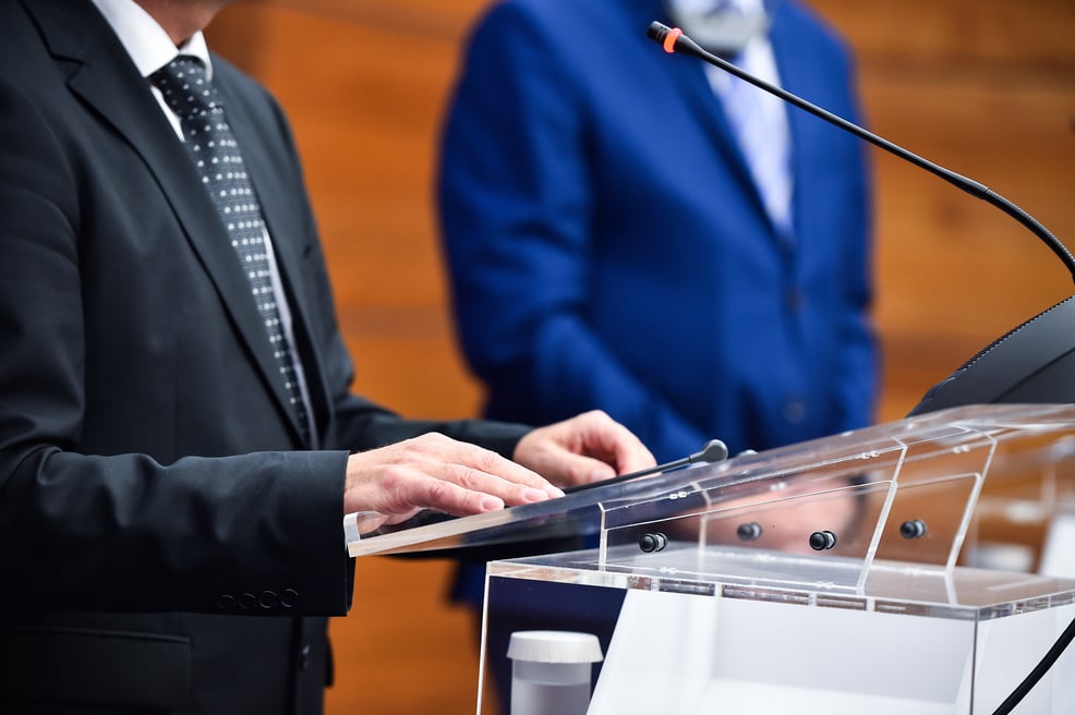 Detail shot with man in suits during a press conference